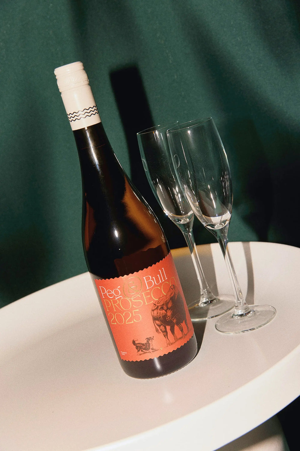 Peg & Bull Prosecco on a serving platter with two glasses