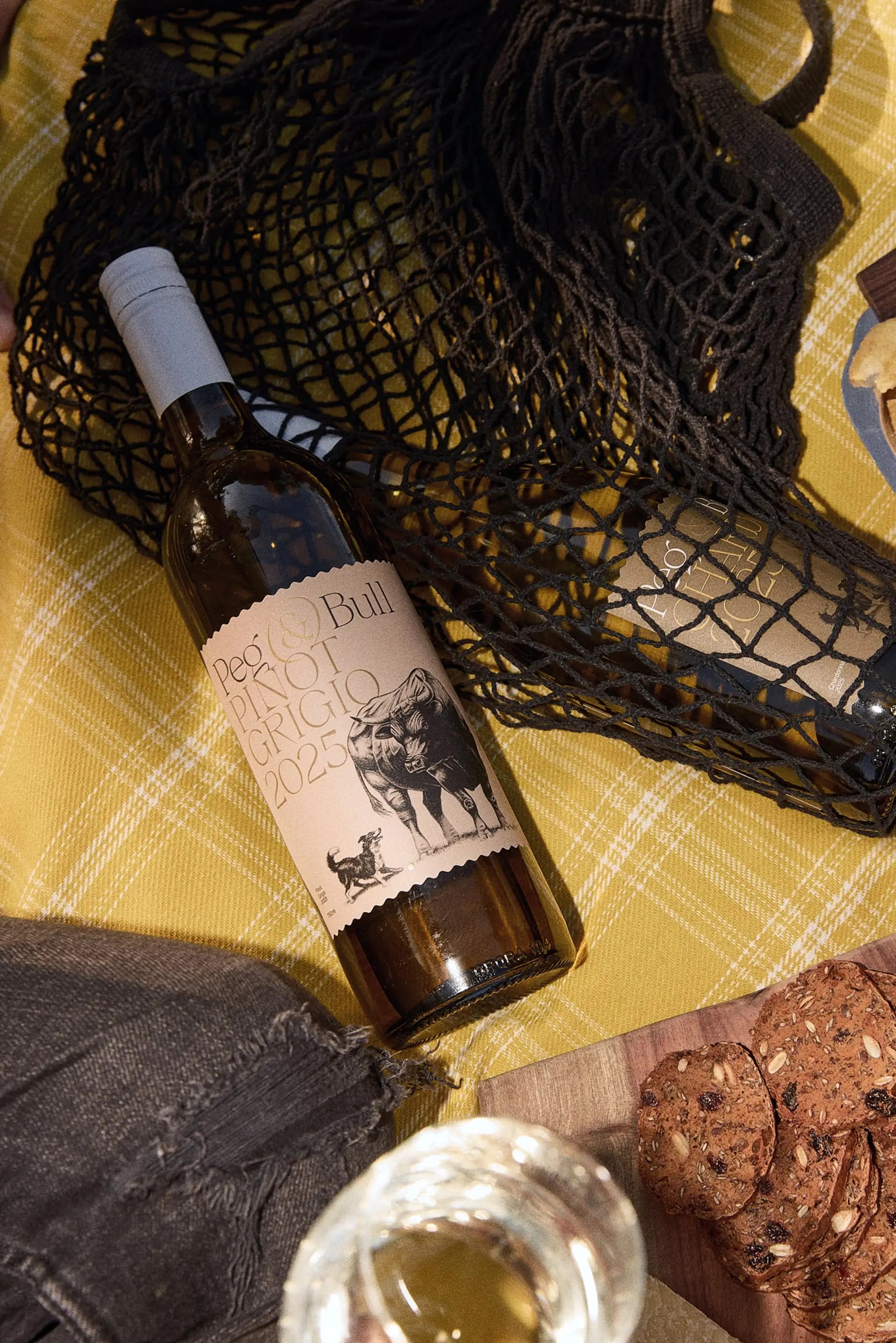 Peg & Bull Pinot Grigio on a picnic rug with snacks